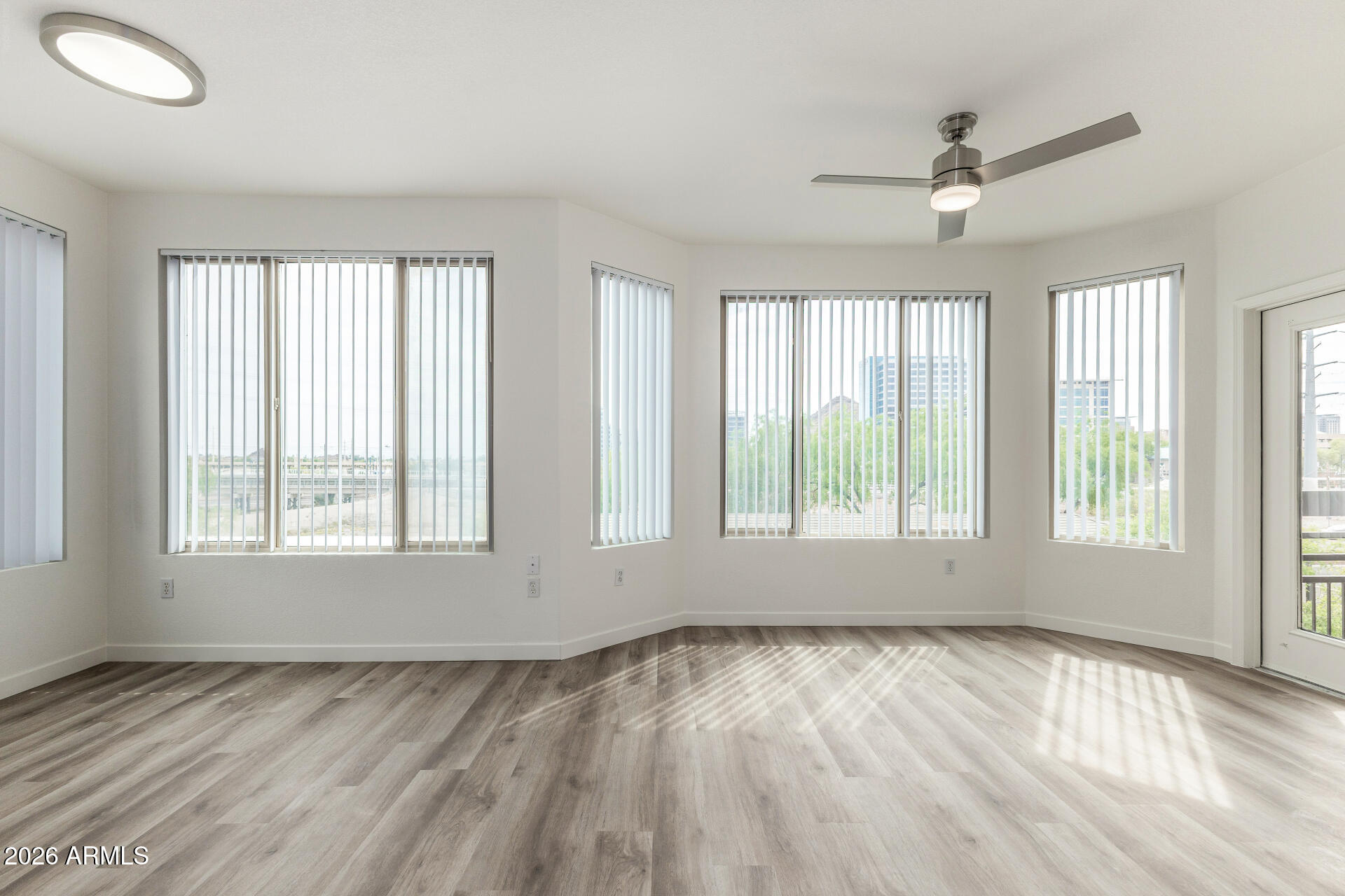 435 West Rio Salado Parkway, Unit 305 Tempe, AZ 85281 - Photo 20 of 44 a view of an empty room with a window and wooden floor