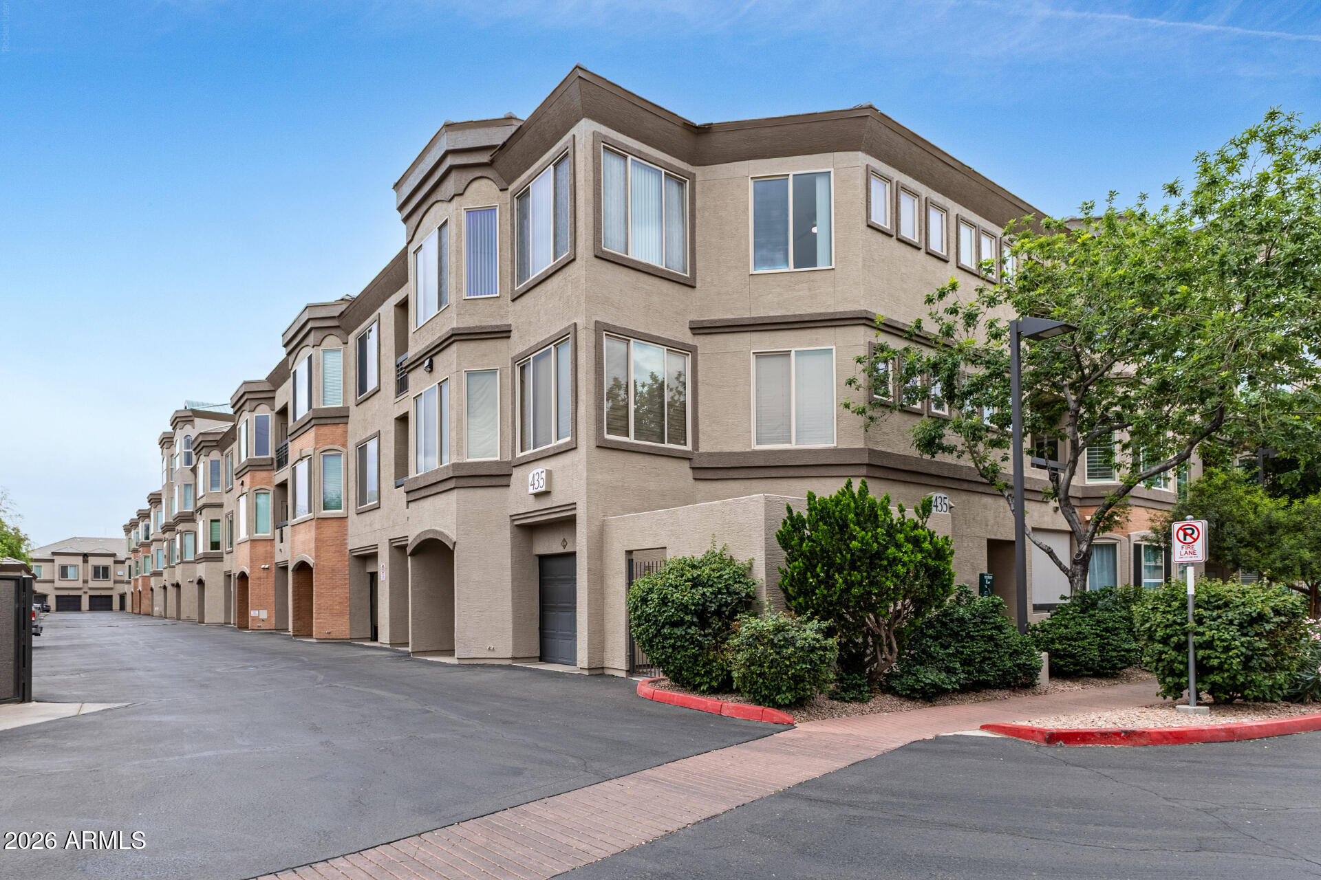 435 West Rio Salado Parkway, Unit 305 Tempe, AZ 85281 - Photo 2 of 44 a view of a white building among the street with palm trees