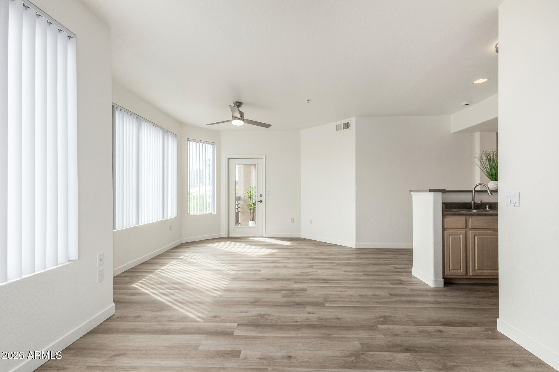 435 West Rio Salado Parkway, Unit 305 Tempe, AZ 85281 - Photo 4 of 44 a view of an empty room with a window and wooden floor