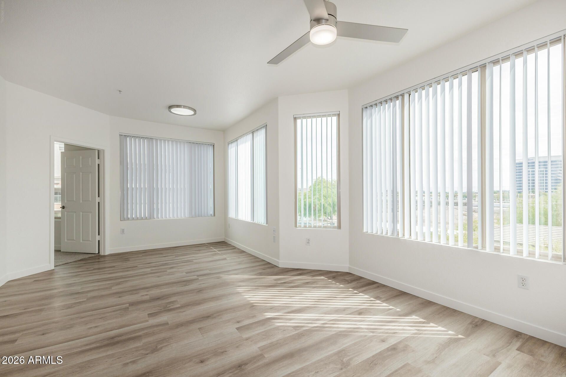 435 West Rio Salado Parkway, Unit 305 Tempe, AZ 85281 - Photo 6 of 44 a view of an empty room with a window and wooden floor