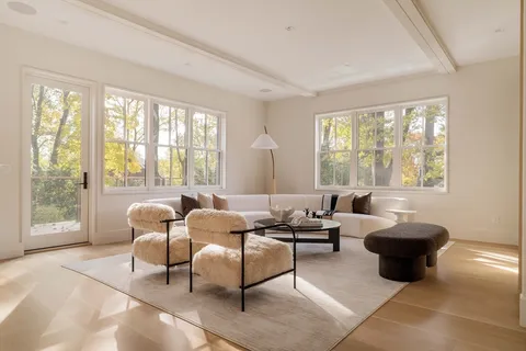 a living room with furniture and large windows