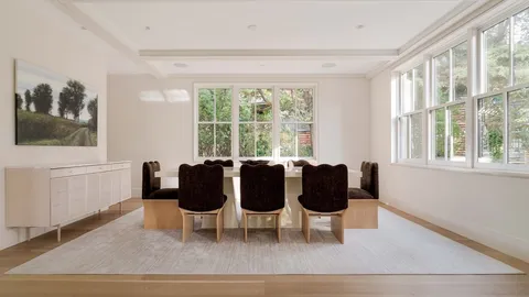 a view of a dining room with furniture and windows