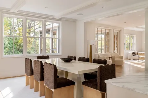 a view of a dining room with furniture and windows