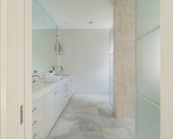 a spacious bathroom with a granite countertop sink a mirror and a bathtub