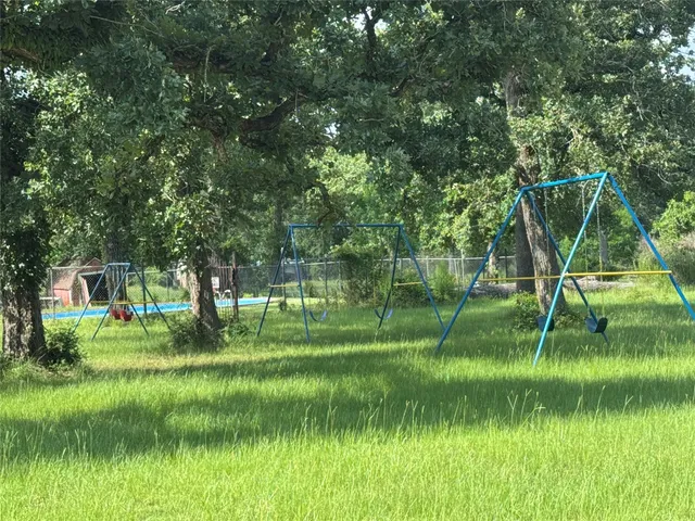 a view of green field in front of a house