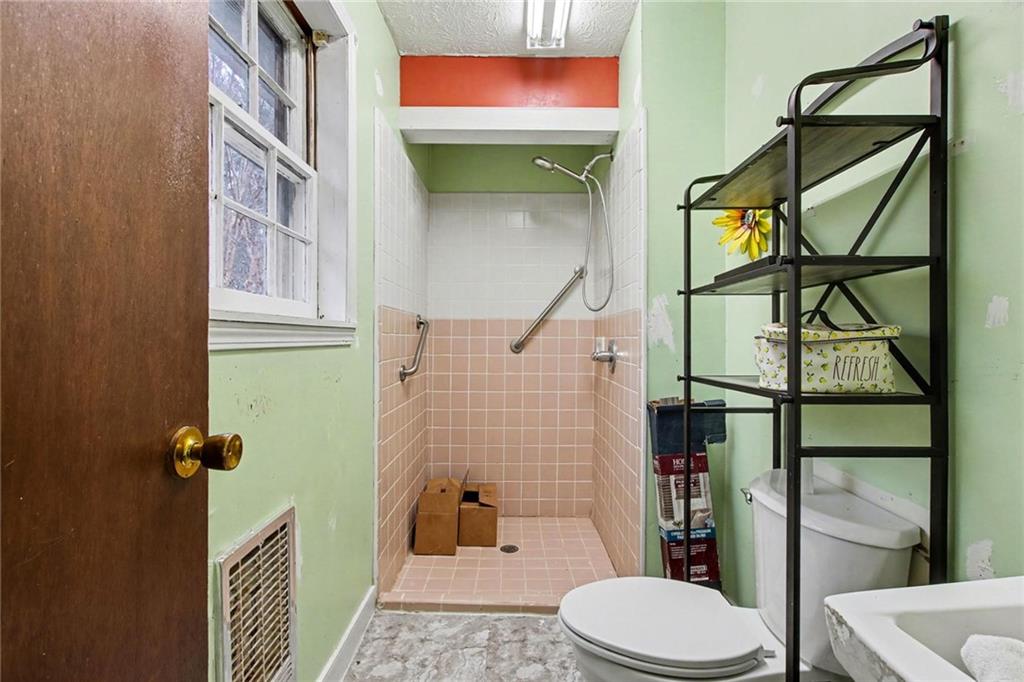 845 Idlewood Road Winder, GA 30680 - Photo 13 of 25 a bathroom with a toilet and a shower