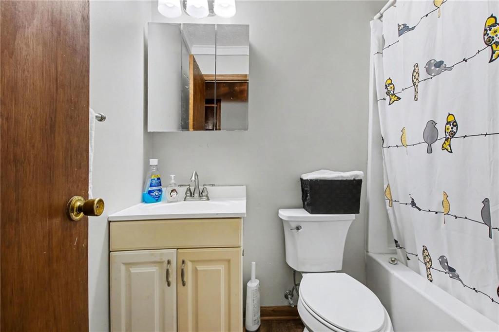 845 Idlewood Road Winder, GA 30680 - Photo 14 of 25 a bathroom with a sink a toilet and a mirror