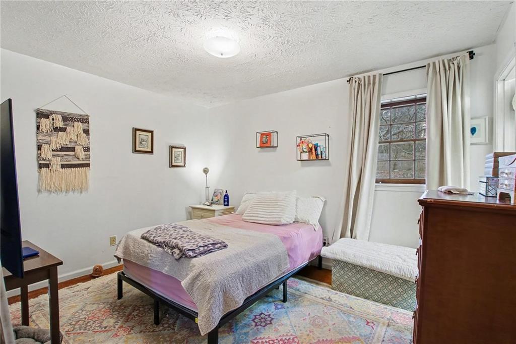 845 Idlewood Road Winder, GA 30680 - Photo 15 of 25 a bedroom with a bed and wooden floor