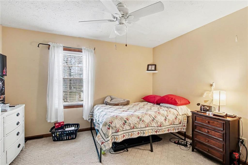 845 Idlewood Road Winder, GA 30680 - Photo 18 of 25 a bedroom with a bed and furniture