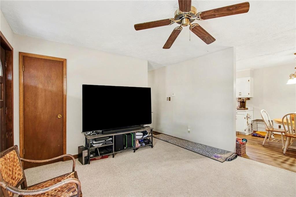 845 Idlewood Road Winder, GA 30680 - Photo 6 of 25 a room with gym equipment and flat screen tv