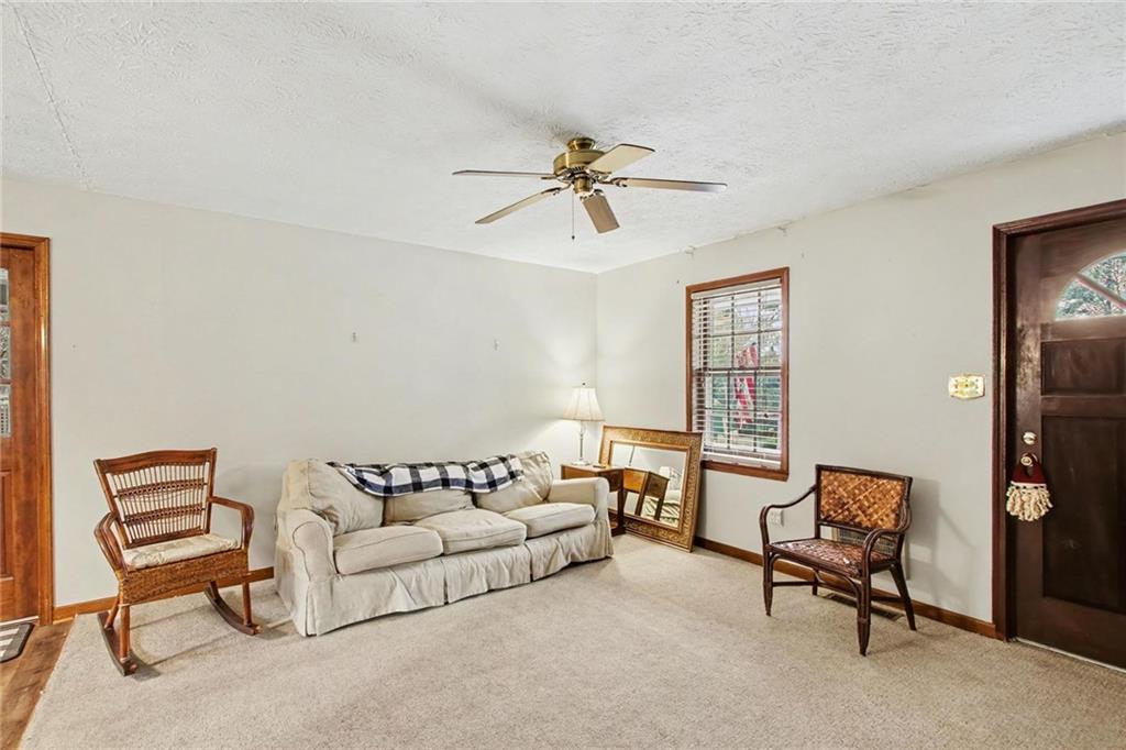 845 Idlewood Road Winder, GA 30680 - Photo 7 of 25 a living room with furniture and a ceiling fan