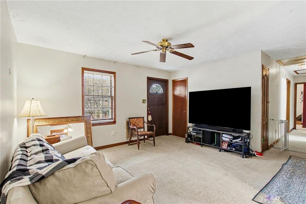 845 Idlewood Road Winder, GA 30680 - Photo 8 of 25 a living room with furniture and a flat screen tv