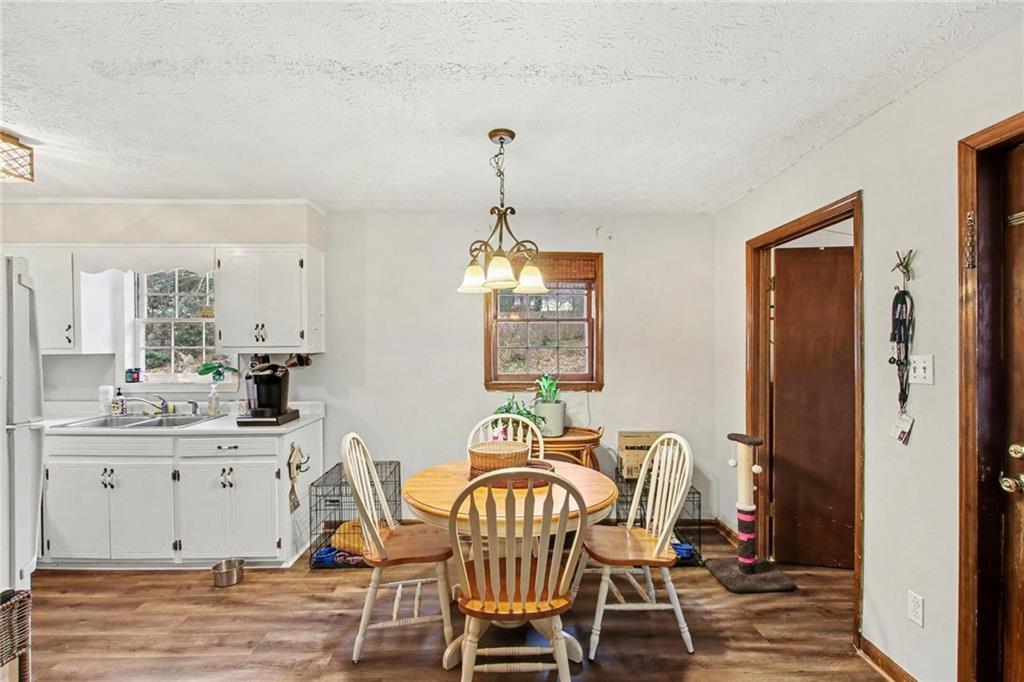 845 Idlewood Road Winder, GA 30680 - Photo 9 of 25 a view of a dining room with furniture window and wooden floor