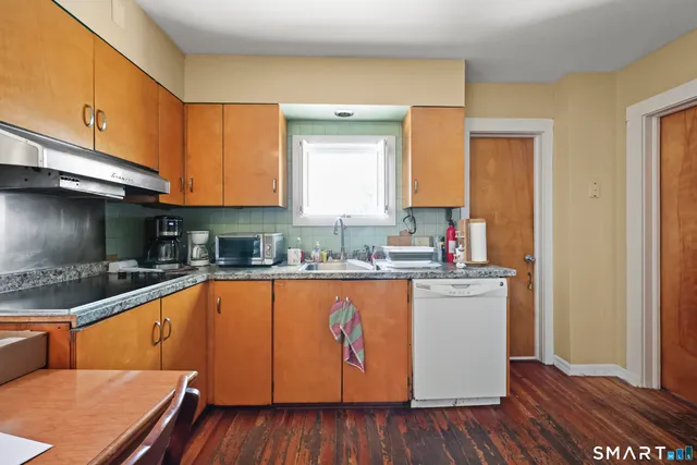 a kitchen with stainless steel appliances granite countertop a sink and cabinets