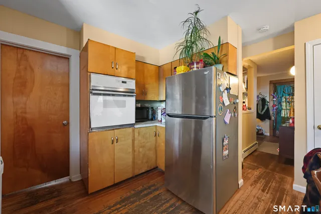 a kitchen with stainless steel appliances granite countertop a refrigerator and a sink