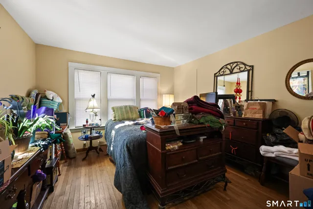 a living room with furniture a wooden floor and a fireplace