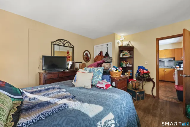 a bedroom with bed and glass door