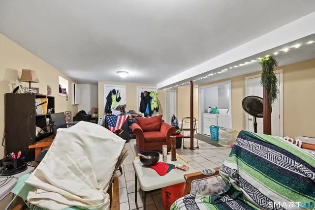 a living room with furniture a rug and a flat screen tv