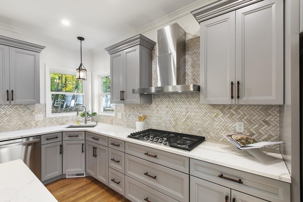 50 Azalea Circle Reading, MA 01867 - Photo 13 of 41 a kitchen with a sink stove and cabinets