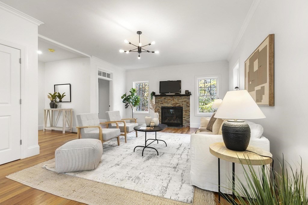 50 Azalea Circle Reading, MA 01867 - Photo 16 of 41 a living room with furniture a fireplace and a flat screen tv