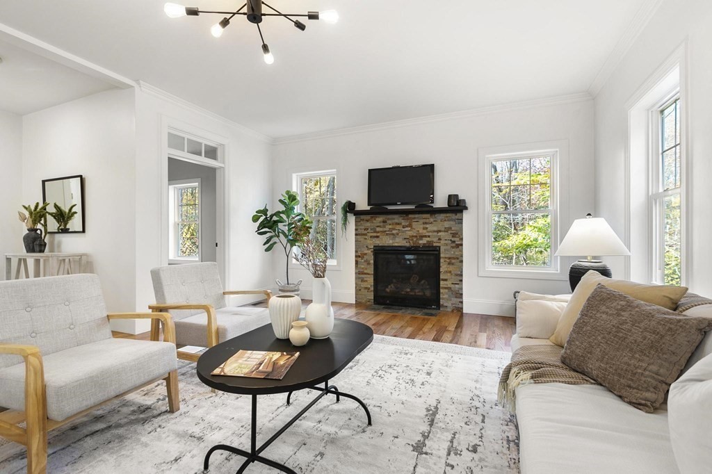 50 Azalea Circle Reading, MA 01867 - Photo 17 of 41 a living room with furniture a fireplace and a flat screen tv