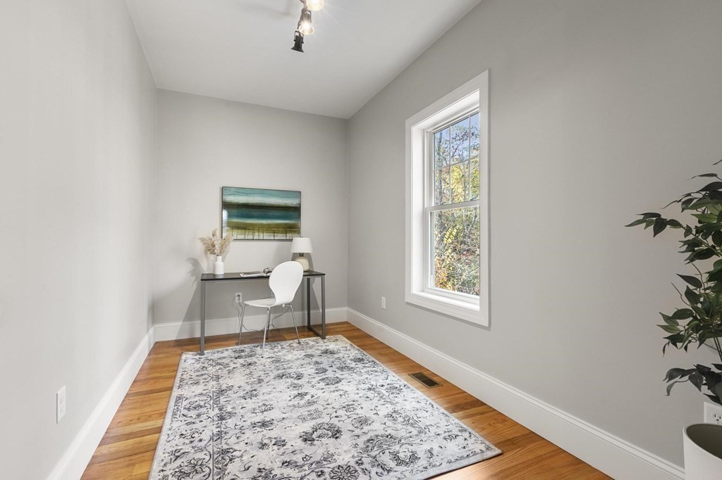 50 Azalea Circle Reading, MA 01867 - Photo 19 of 41 a living room with a couch and a potted plant