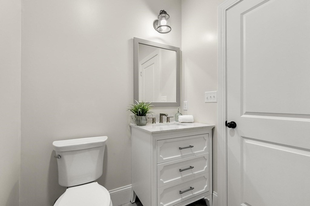 50 Azalea Circle Reading, MA 01867 - Photo 20 of 41 a bathroom with a toilet a sink a vanity and mirror