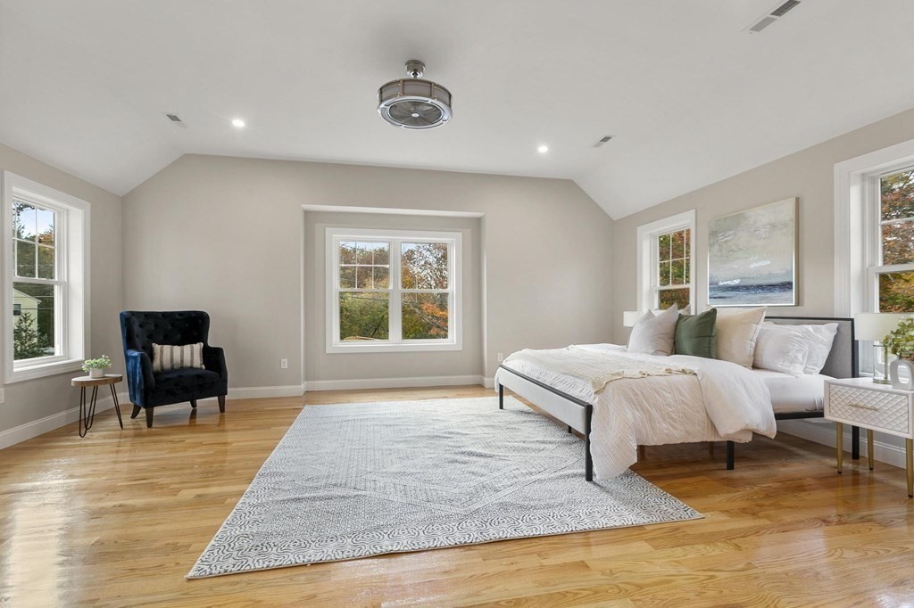 50 Azalea Circle Reading, MA 01867 - Photo 22 of 41 a spacious bedroom with a bed a table and chair