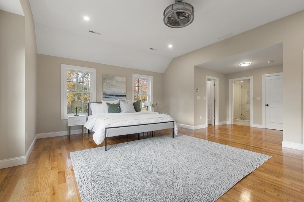 50 Azalea Circle Reading, MA 01867 - Photo 23 of 41 a spacious bedroom with a bed and a chandelier