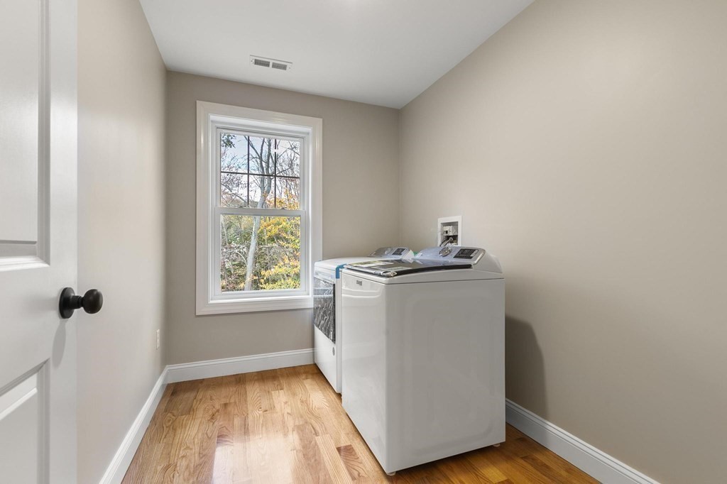50 Azalea Circle Reading, MA 01867 - Photo 27 of 41 a utility room with wooden floor washer and dryer