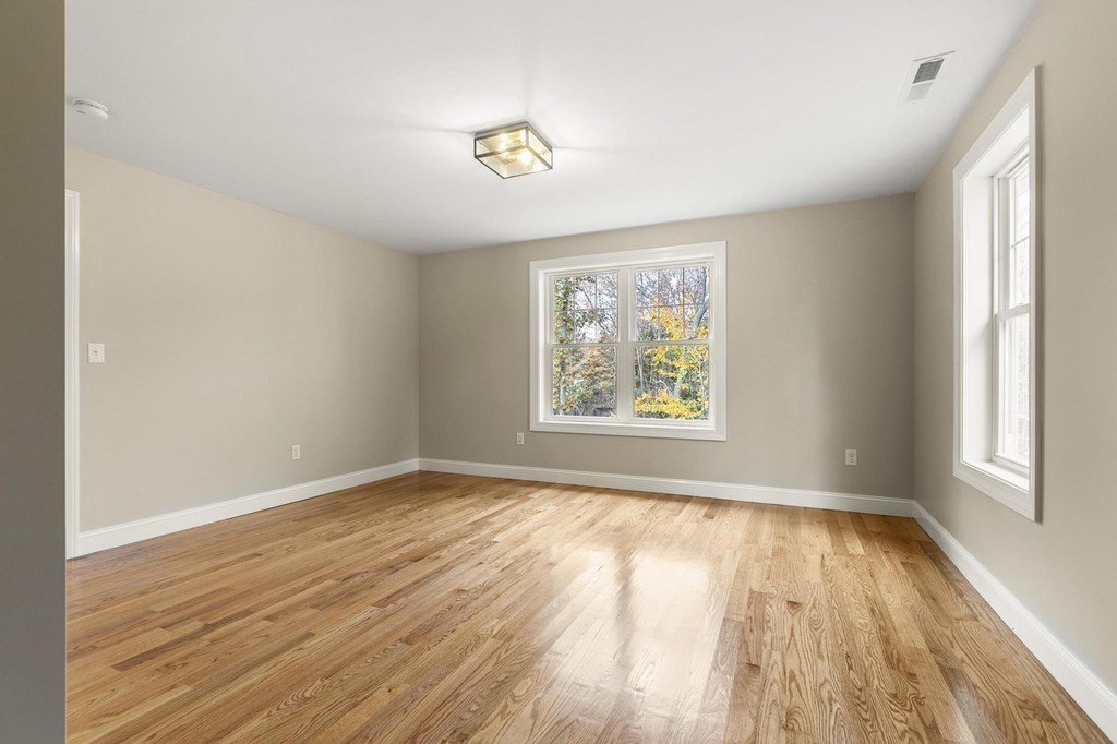 50 Azalea Circle Reading, MA 01867 - Photo 28 of 41 an empty room with wooden floor and windows