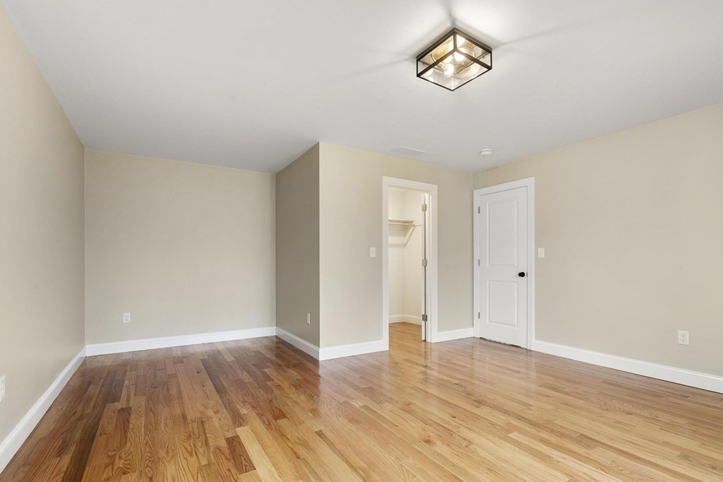 50 Azalea Circle Reading, MA 01867 - Photo 29 of 41 a view of an empty room with wooden floor