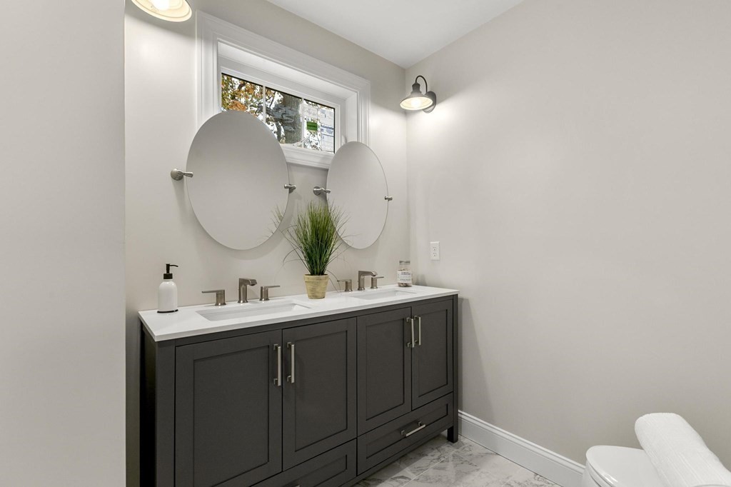 50 Azalea Circle Reading, MA 01867 - Photo 31 of 41 a bathroom with a toilet sink and mirror