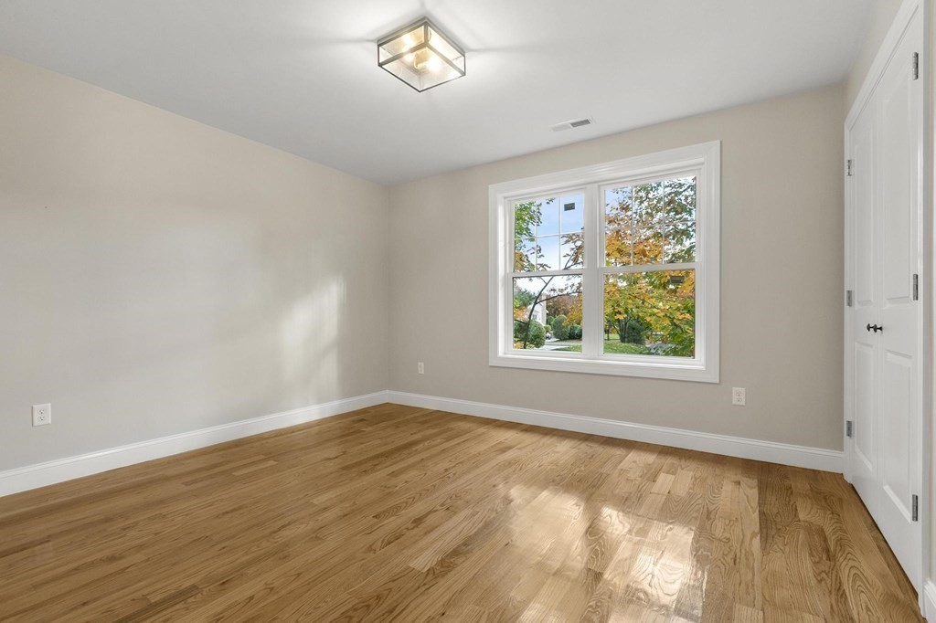 50 Azalea Circle Reading, MA 01867 - Photo 32 of 41 an empty room with wooden floor and windows