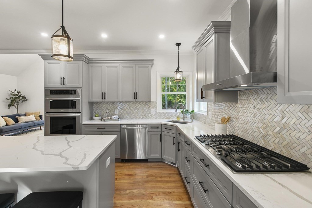 50 Azalea Circle Reading, MA 01867 - Photo 8 of 41 a kitchen with a stove a sink a refrigerator and cabinets