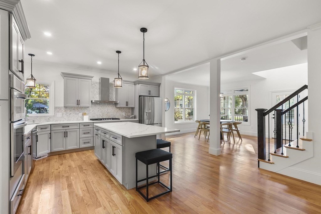 50 Azalea Circle Reading, MA 01867 - Photo 9 of 41 a large white kitchen with lots of counter space a sink appliances and dining table
