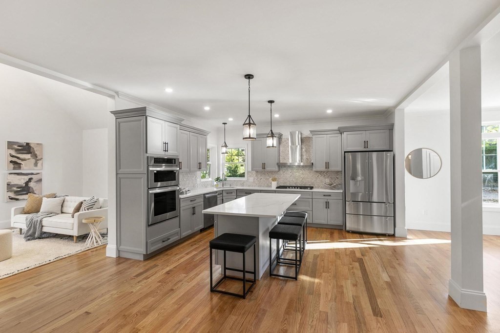 50 Azalea Circle Reading, MA 01867 - Photo 10 of 41 a kitchen with stainless steel appliances refrigerator dining table and chairs