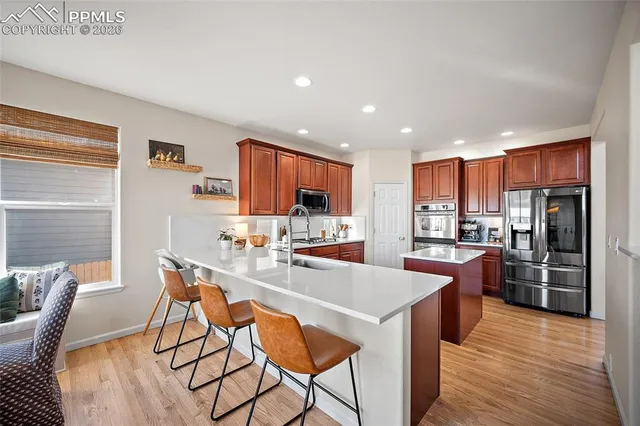 a kitchen with stainless steel appliances kitchen island granite countertop a sink and cabinets