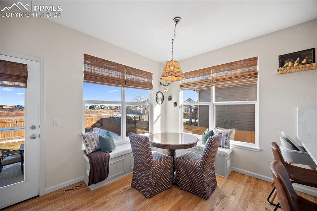 9393 St.George Road Peyton, CO 80831 - Photo 15 of 49 a dining room with furniture a chandelier and wooden floor