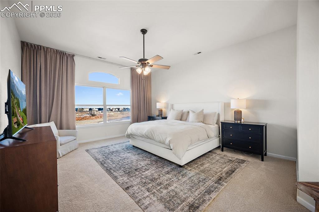 9393 St.George Road Peyton, CO 80831 - Photo 28 of 49 a spacious bedroom with a bed and a flat screen tv