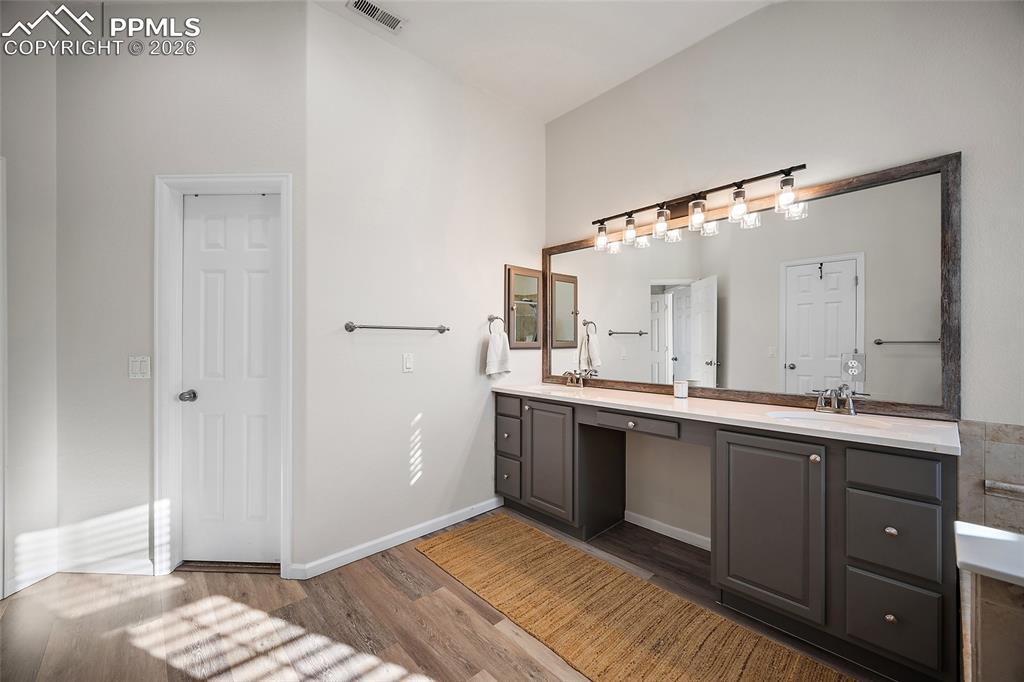 9393 St.George Road Peyton, CO 80831 - Photo 32 of 49 a spacious bathroom with a double vanity sink and mirror