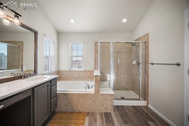 a bathroom with a double vanity sink toilet mirror and bathtub