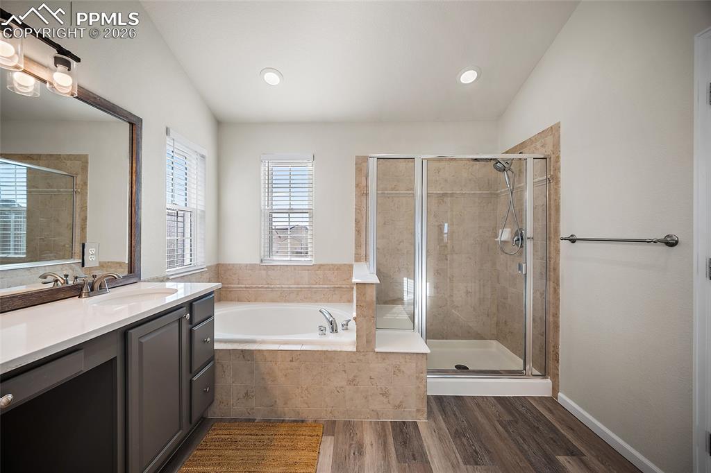 9393 St.George Road Peyton, CO 80831 - Photo 34 of 49 a bathroom with a double vanity sink toilet mirror and bathtub