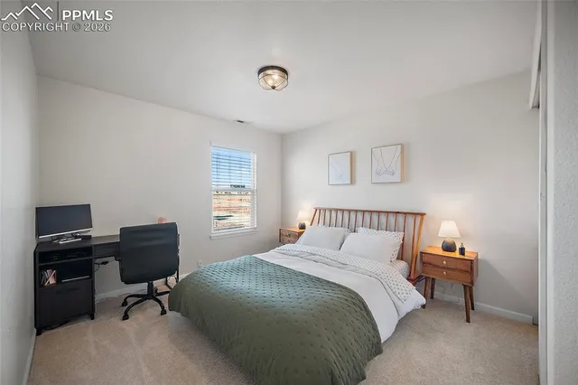 a bedroom with a bed and a bookshelf