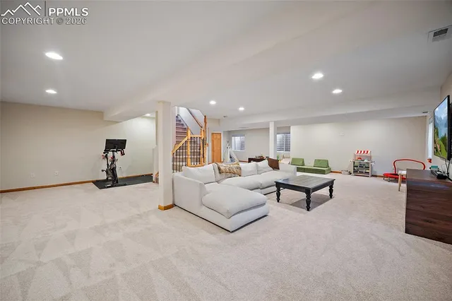 a living room with furniture and a gym equipment