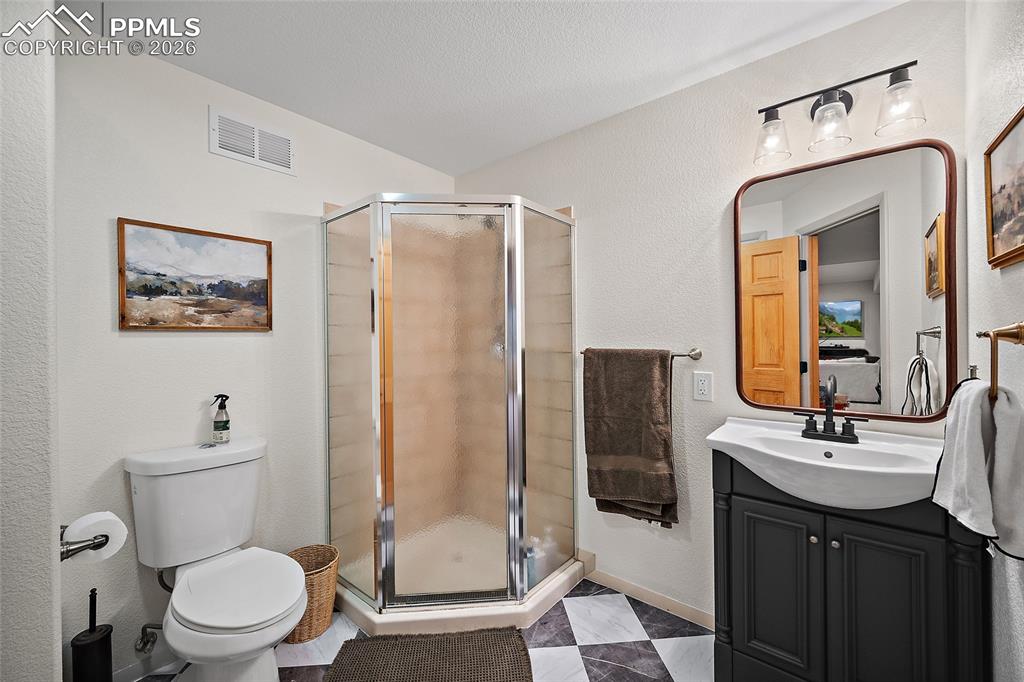 9393 St.George Road Peyton, CO 80831 - Photo 40 of 49 a bathroom with a toilet sink shower and mirror