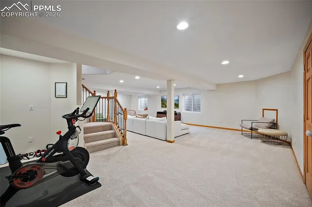 a view of a livingroom with furniture and a gym equipment