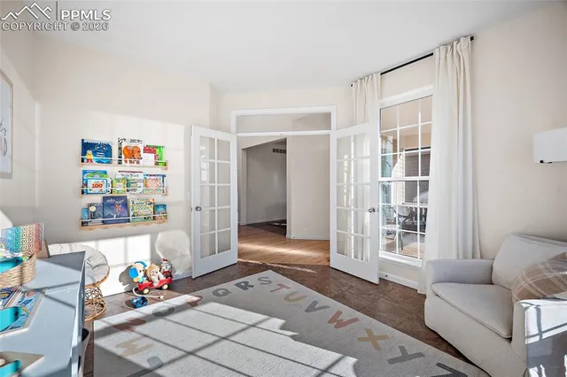 a living room with furniture and flowers