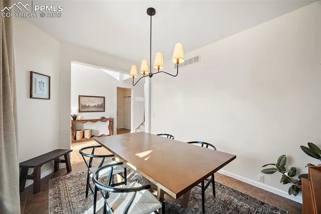 a view of a room that has a table and chairs in it