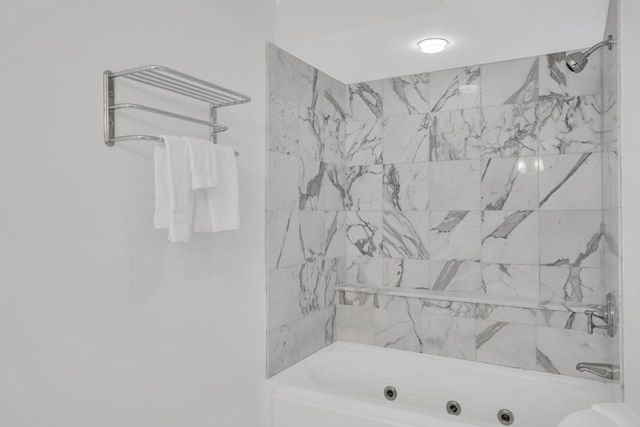 a bathroom with a bathtub and shower